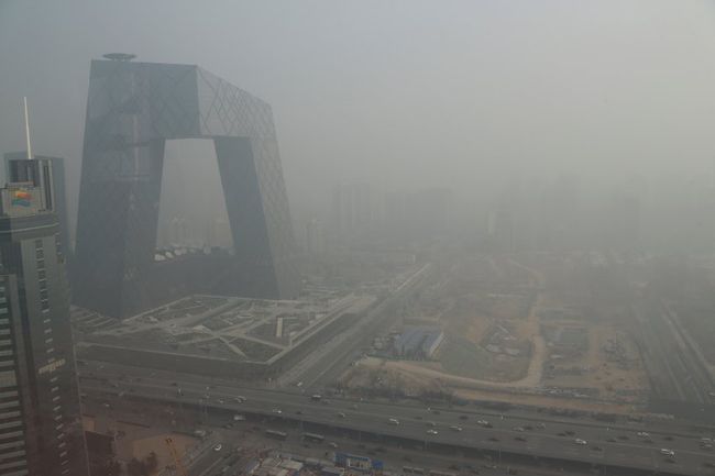 China Central Television building is seen next to construction site in heavy haze in Beijing's central business district